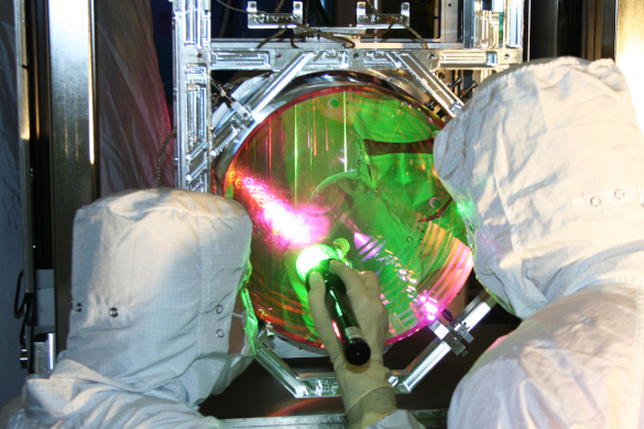 Technicians inspect the coating on one of LIGO's four mirrors.